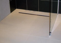 Wet room floor using Linear drain deck. Note the straight waste outlet gully.