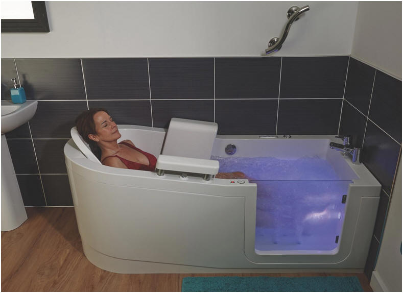 Pure luxury. Recline in the Easy Riser walk in bath. Shown here equipped with 14 jet warm air spa and chromotherapy lighting viewed through the glass entry door.
