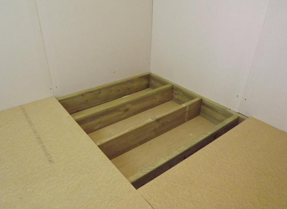 Remove a section of floor board equivalent to the size your shower area will be. Expose the floor joists.