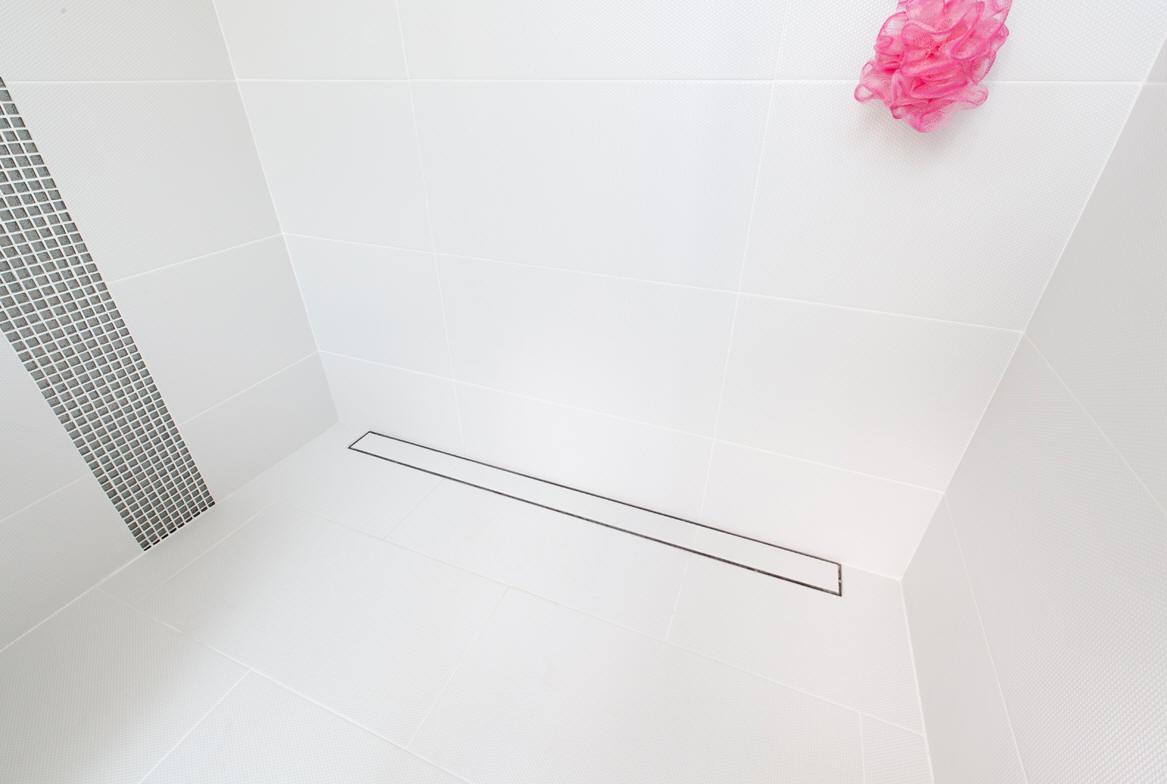 Novellini MONO Deck wet room shower floor former will a single slope to a linear wall drain.