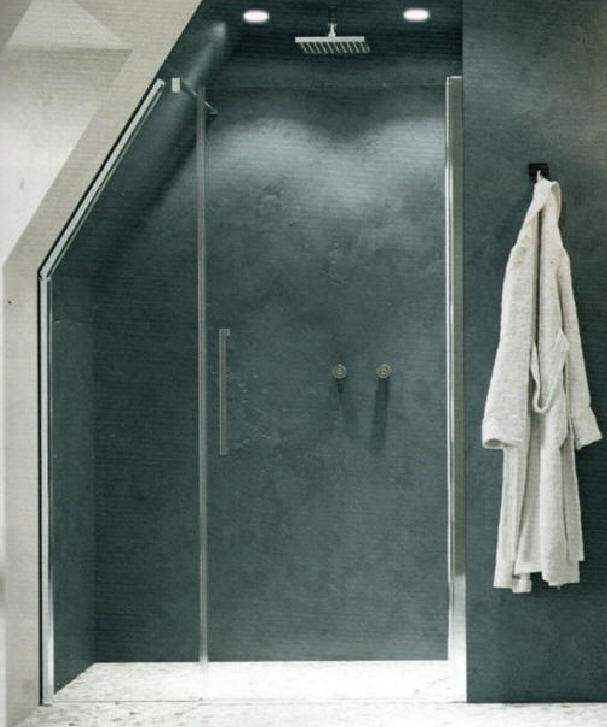 Shower door with fixed angled panel and hinged inline door.